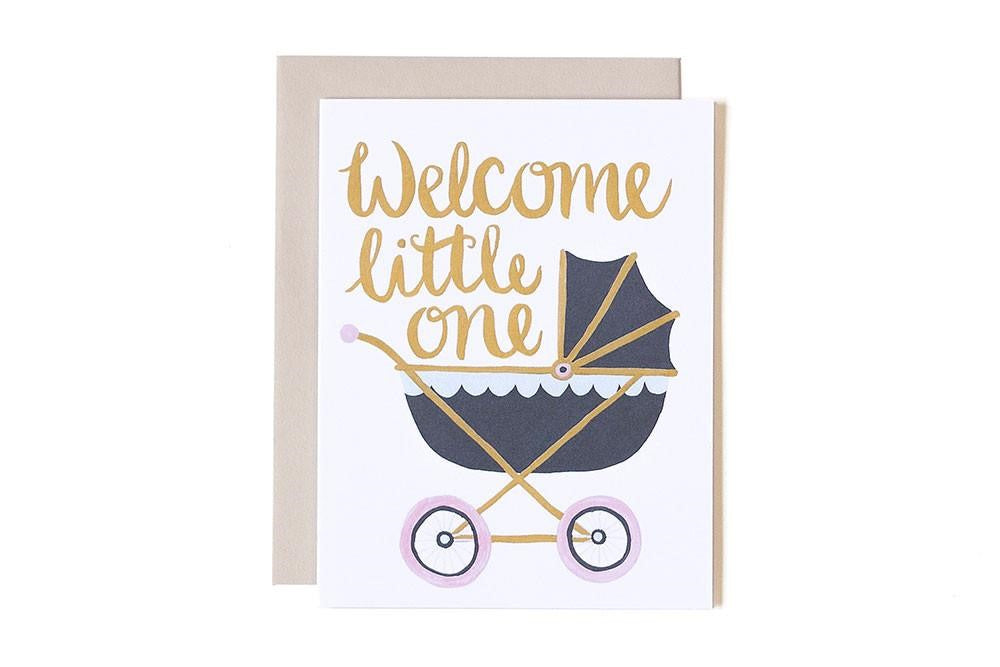 The message "welcome little one" above a dark blue, old-fashion baby carriage on a white background.