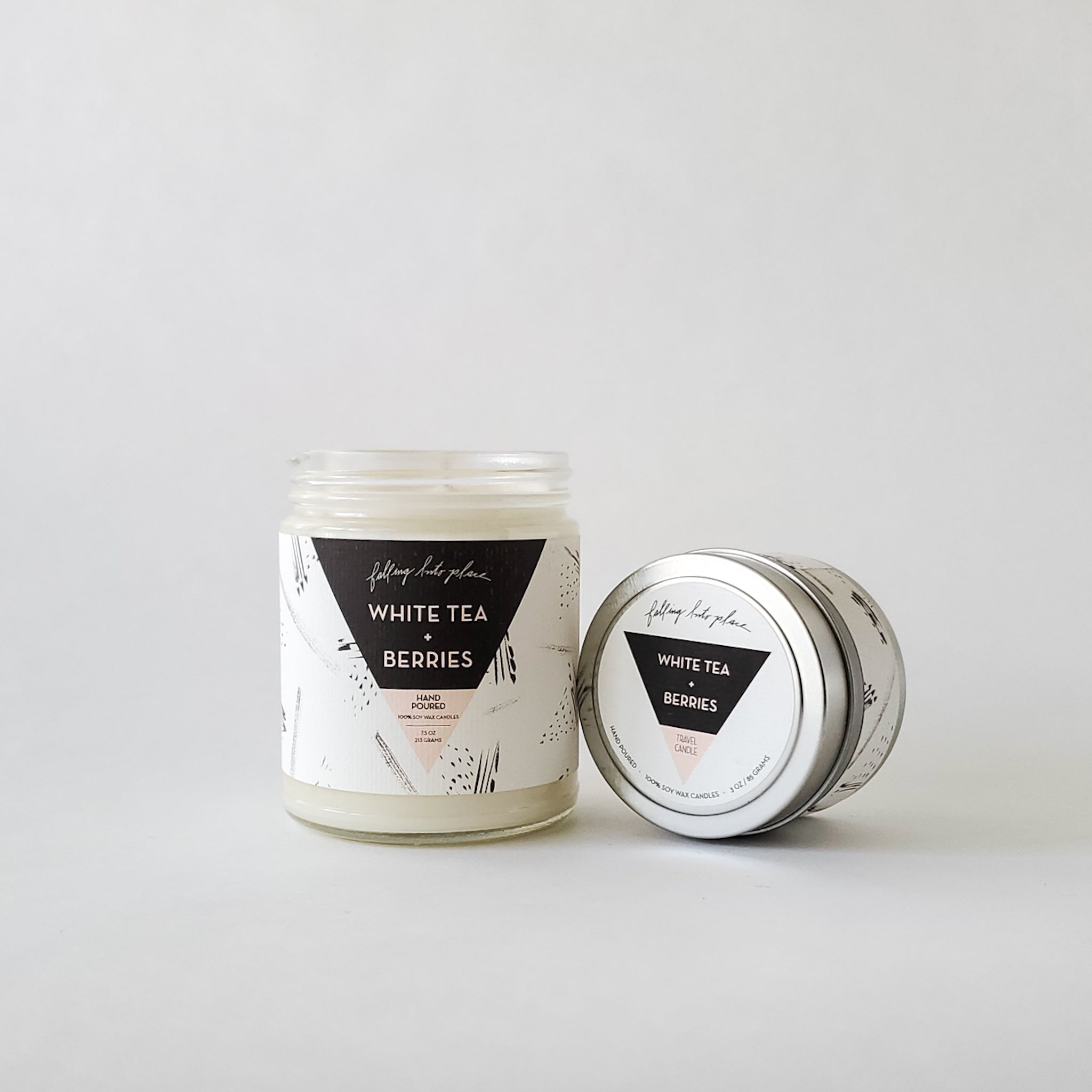 Artistic jar and tin candles with black and white labels. 